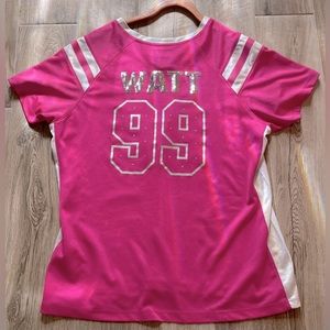 A pink jersey of watt number 99 on the Texans football team